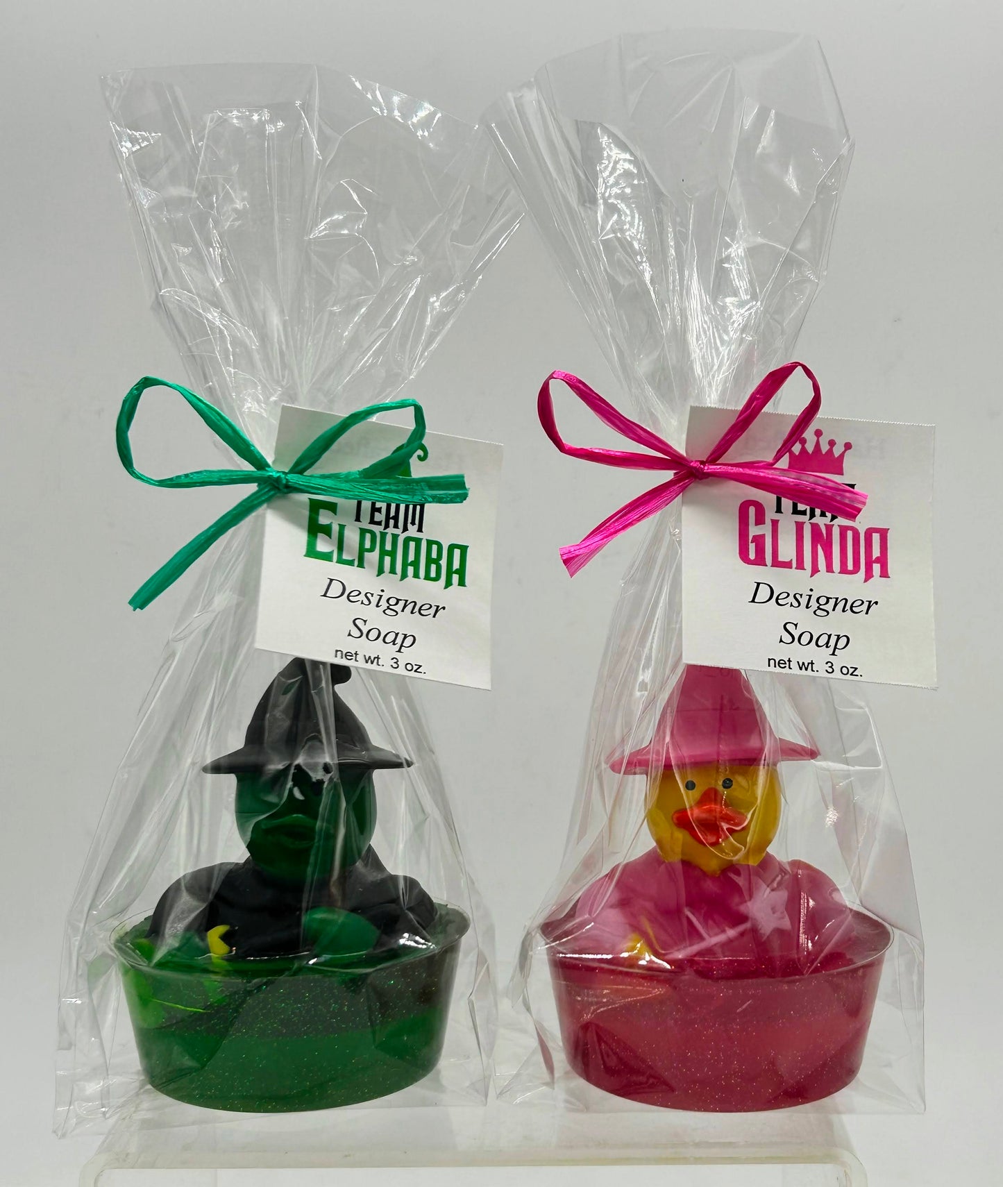 Glinda & Elphaba rubber duck toy in colored soap with dish in a cello bag ited with ribbon and themed tag