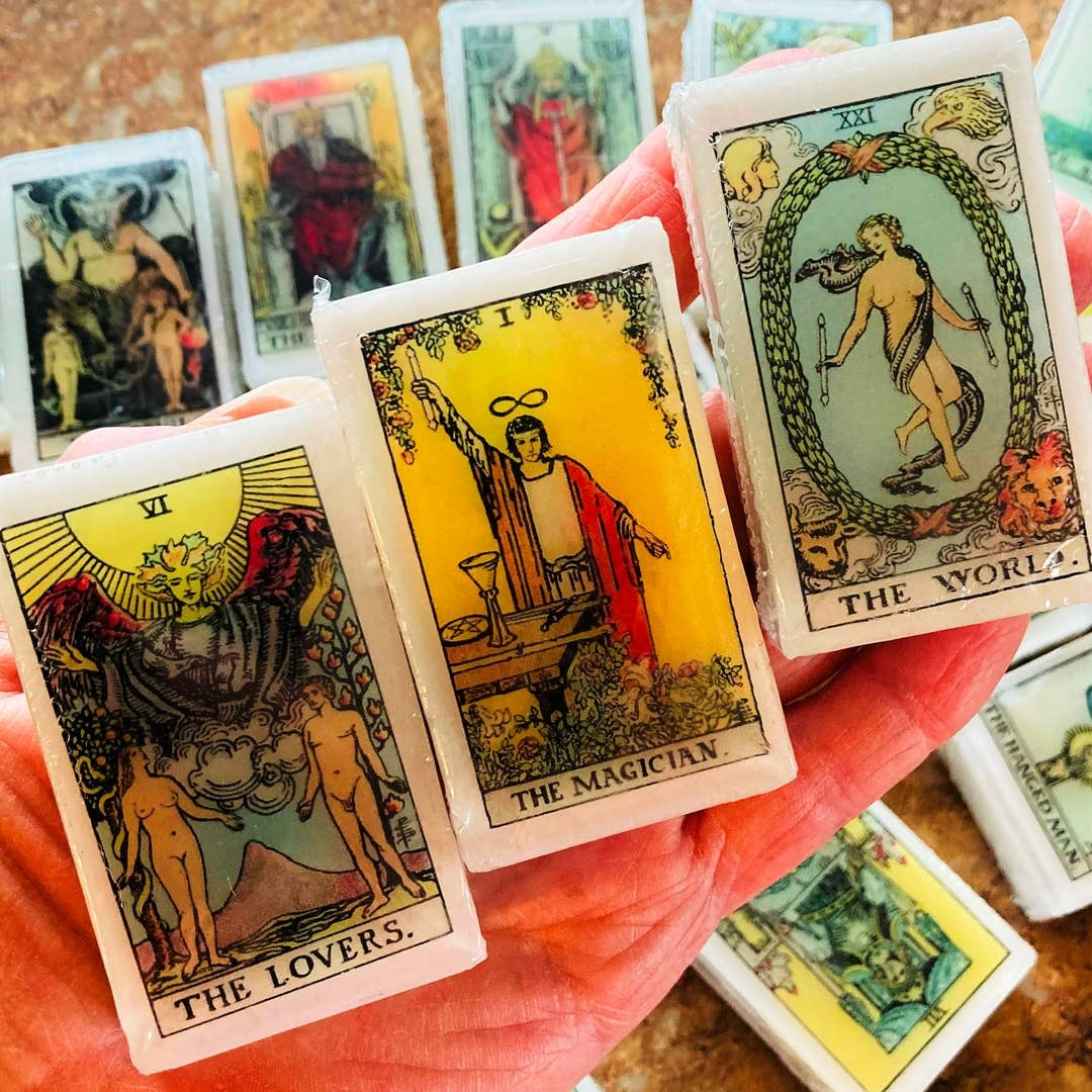 Collection of image cards held in a hand, with 'The Magician' card prominently displayed.